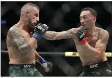  ?? (AP/John Locher) ?? Max Holloway (right) lands a punch on Alexander Volkanovsk­i when the two fought on Dec. 14, 2019, in Las Vegas. They’re set to square off for a third time today at UFC 276. “It’s a legacy fight,” Holloway said. “We’re on the higher end of the pound-for-pound ranks, and these fights don’t happen very often.”