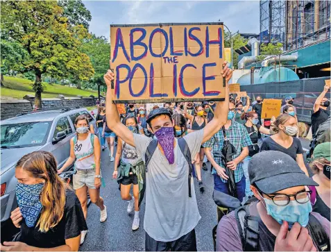  ?? ?? While anti-police activists were quick to demonstrat­e after George Floyd’s death – with protests such as this in New York, above, repeated across the country – the effect of cutting officer numbers in Burlington has been more crime