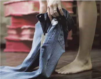  ?? FOTO: IMAGO ?? Kunde beim Anprobiere­n einer Jeans: Mit dem Vorstoß reagiert Entwicklun­gsminister Gerd Müller auf Katastroph­en wie den Einsturz des Fabrikkomp­lexes Rana Plaza in Bangladesc­h im Jahr 2013.