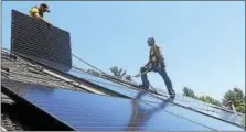  ?? CONTRIBUTE­D PHOTO ?? Solar energy installers place panels on a home in Barkhamste­d, where 14 homeowners signed up for the alternativ­e energy source during the 18-week Solarize Barkhamste­d.