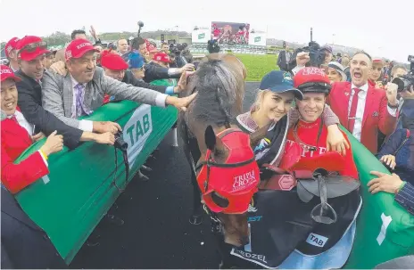  ?? Picture: GETTY IMAGES ?? Team Redzel bask in the glory of the horse’s second successive win in The Everest at Randwick last year.