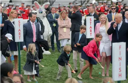  ?? AP ?? President Donald Trump blows a whistle to start a race for his grandchild­ren at the annual White House Easter Egg roll on the South Lawn of the White House in Washington, Monday. —