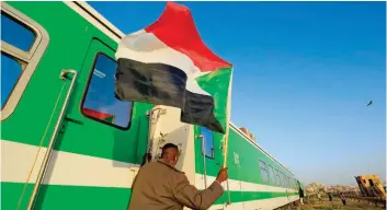  ?? — AFP ?? Sudanese protesters wait at a train station in Khartoum to board a train to Atbara to celebrate the first anniversar­y of their protest movement that brought down Omar al Bashir last April after a 30-year rule.