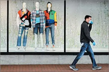  ?? CHARLES KRUPA/AP ?? A man walks past a Macy’s in Boston. U.S. retail sales plummeted last month in an unpreceden­ted decline.