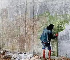  ??  ?? IF ONLY TALENT WERE TRULY VIRAL — This ‘homeless’ man, also suffering from some form of memory or mental disorder, went viral on Facebook after a photo of him painting a public wall using only leaves in Bayawan City, Negros Oriental was posted early this month. Word has it that he also writes Latin words. (Photo courtesy of Clyde Elloren Tapdasan)