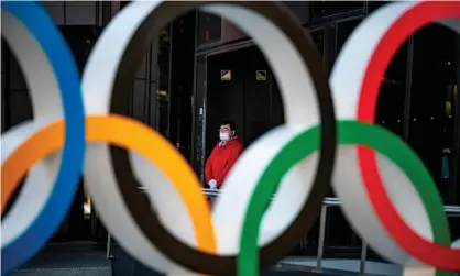  ?? Photograph: Philip Fong/AFP/Getty Images ?? A member of staff outside the Olympic Museum in Tokyo.