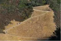  ??  ?? Above: Hikers make their way up the Trapline Trail at Las Trampas Wilderness Regional Preserve in San Ramon.