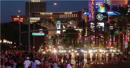  ?? (Mike Blake/Reuters) ?? TOURISTS ENJOY the Las Vegas Strip last month.