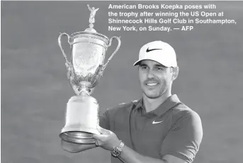  ??  ?? American Brooks Koepka poses with the trophy after winning the US Open at Shinnecock Hills Golf Club in Southampto­n, New York, on Sunday. — AFP