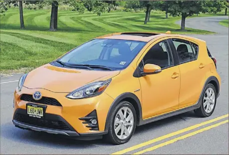  ??  ?? THE 2018 TOYOTA PRIUS C is the lowest priced hybrid in Prius’ four-model line-up. While the 1.5-liter, Atkinsoncy­cle engine carries over, Toyota has tweaked the styling to compete in the popular crossover hatchback segment.