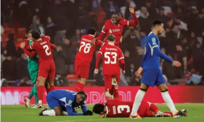  ?? Photograph: Tom Jenkins/The Guardian ?? Liverpool players celebrate victory and leave their Chelsea counterpar­ts on the floor.