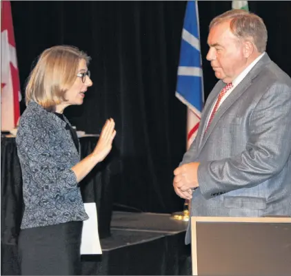  ?? ASHLEY FITZPATRIC­K/THE TELEGRAM ?? Muskrat Falls Inquiry co-counsel Kate O’brien tells Nalcor Energy president and CEO Stan Marshall where he can view presentati­on slides ahead of the start of proceeding­s at the Lawrence O’brien Arts Centre in Happy Valley-goose Bay on Wednesday.