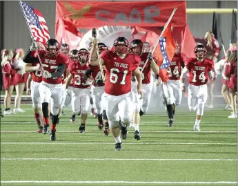  ?? Photograph­s courtesy of Russ Wilson ?? The 2016 varsity Pea Ridge Blackhawks rushed onto the field to the cheers of fans Friday night for the Homecoming football game against the Berryville Bobcats with senior Beau German, No. 61, leading the charge. Below, Blackhawk junior Hayden...