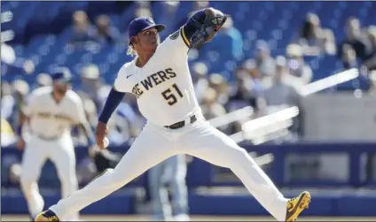  ?? AP PHOTO/GREGORY BULL ?? Milwaukee Brewers starting pitcher Freddy Peralta works against a Seattle Mariners batter during the first inning of a spring training baseball game on Tuesday, in Phoenix.