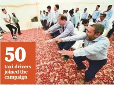  ?? Antonin Kélian Kallouche/Gulf News ?? ■ Taxi drivers go through an exercise routine during the Watch Your Campaign at DTC headquarte­rs in Muhaisnah yesterday.