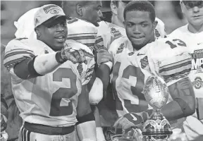  ?? ?? Ohio State’s Michael Doss, left, and Maurice Clarett celebrate winning the national championsh­ip on Jan. 3, 2003.