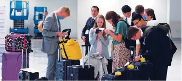  ?? Agence France-presse ?? ↑
Passengers complete forms at Benito Juarez Internatio­nal airport in Mexico City on Wednesday.