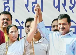  ?? PTI ?? Delhi Chief Minister Arvind Kejriwal and West Bengal Chief Minister Mamata Banerjee during a rally against demonetisa­tion of currency notes, at Azadpur mandi in New Delhi on Thursday