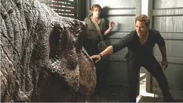  ??  ?? Claire (Howard) and Owen (Pratt, also below) try not to wake a T. rex in ‘Jurassic World: Fallen Kingdom’. — Courtesy of Universal Studios