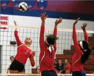  ?? RANDY MEYERS — THE MORNING JOURNAL ?? Briana Bowyer of Firelands spikes the ball over Lauren Sands, left, and Kayliana Barbee of Oberlin during the first game.
