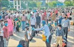  ?? PTI ?? ■
Migrants undergo thermal screening before they board buses in Surat on Tuesday.