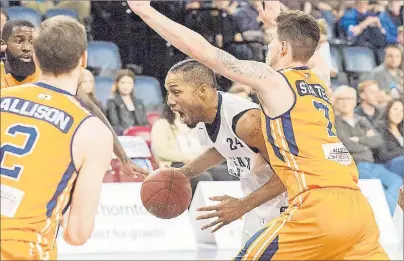  ?? CHRONICLE HERALD PHOTO ?? With a howl, Hurricanes’ centre Anthony Cox blows by Storm forward Brad States Tuesday night in National Basketball League of Canada playoff action in Halifax.