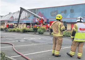  ??  ?? On the scene
Firefighte­rs remained at the retail park for most of Saturday