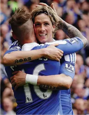  ??  ?? I’ve still got it: Chelsea’s Fernando Torres is hugged by Raul Meireles after scoring his second goal against Leicester during their English FA Cup quarter final at Stamford Bridge yesterday.