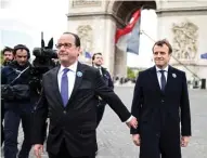  ?? - Reuters ?? IN REMEMBRANC­E : Outgoing French President Francois Hollande, left, and President-elect Emmanuel Macron attend a ceremony to mark the end of World War II at the Tomb of the Unknown Soldier at the Arc de Triomphe in Paris, France, on Monday.