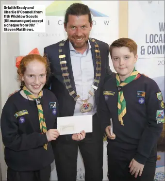  ??  ?? Orlaith Brady and Charlie O’Connell from 11th Wicklow Scouts (Kilmacanog­ue) accept a cheque from Cllr Steven Matthews.