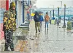  ??  ?? Security personnel stand guard during shutdown in Srinagar, on Thursday
