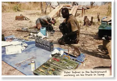  ??  ?? Peter Dafner in the background working on his truck in camp.