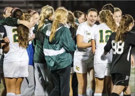  ?? JAMES BEAVER/FOR DIGITAL FIRST MEDIA ?? Lansdale Catholic players celebrate their 1-0 victory over St. Basil Academy on Tuesday night.