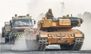  ?? BURAK KARA GETTY IMAGES ?? A Turkish army tank moves toward the Syrian border Friday. U.S. President Donald Trump gave Turkey the green light to invade this month when he withdrew 1,000 troops from the region.