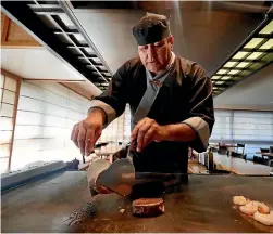  ??  ?? William Gould cooking at the teppanyaki table.