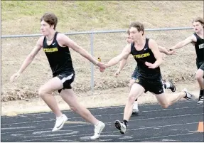  ?? MIKE ECKELS SPECIAL TO THE ENTERPRISE-LEADER ?? Prairie Grove’s Landon Semrad (left) takes the baton from Wyatt Young during the boys 4x100 relay race at a track and field meet hosted by Gravette on Thursday. Prairie Grove placed second with a time of 45.51.