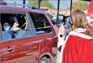  ?? COURTESY PHOTO ?? After handing out toys and other gifts, Santa Claus and Mrs. Claus bid farewell to students during the Fontana Unified School District’s 24th annual Fontana Santas toy distributi­on for elementary school families Saturday at the school district office’s parking lot.