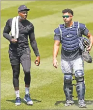  ?? Kathy Willens / Associated Press ?? New York Yankees relief pitcher Aroldis Chapman, left, leaves the field after a bullpen session with catcher Gary Sanchez on July 5 at Yankee Stadium.