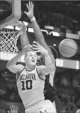  ?? Elsa Garrison Getty Images ?? VILLANOVA’S DONTE DiVINCENZO goes for the rebound against West Virginia en route to the Wildcats’ 90-78 Sweet 16 win.