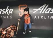  ??  ?? Vying for the title of cutest fan at FanFest was 1-year-old Victoria Santos, shown in a dugout.