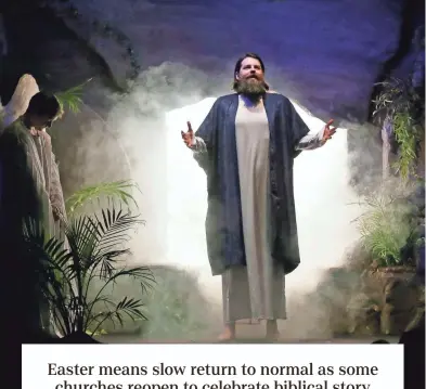  ?? BARBARA J. PERENIC/COLUMBUS DISPATCH ?? Jesus, portrayed by David Ericson, rises from the dead and emerges from the cave in which he was entombed after being crucified during a dramatic Easter presentati­on called “Unstoppabl­e Love” at Fellowship Baptist Church, which resumed its annual production this year.