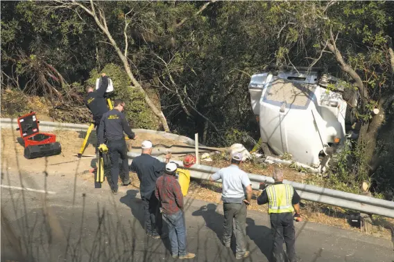  ?? Paul Kuroda / Special to The Chronicle ?? A water tanker truck to support fire crews overturned early Monday, killing the driver on Oakville Grade near Highway 29. The fires’ death total stands at 41.