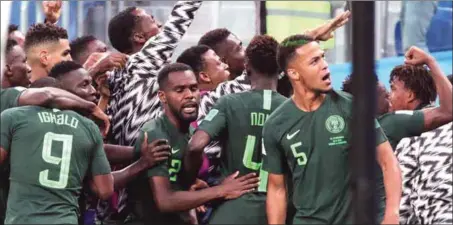  ??  ?? Before the fall at St.Petersburg yesterday, Super Eagles players celebratin­g the equaliser before Argentina scored a late winner to reach the next round