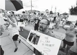  ?? KENNETH K. LAM/BALTIMORE SUN ?? Jeremy Novak, center, of Jarrettsvi­lle, joins over a hundred other parents and students who gathered outside Harford County Public School Board of Education on Aug. 16 to protest the mask mandate for everyone inside school buildings.