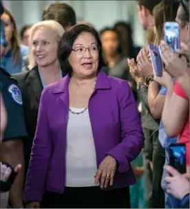  ?? The Associated Press ?? Sen. Mazie Hirono, D-Hawaii, with Sen. Kirsten Gillibrand, D-N.Y., left, is applauded by demonstrat­ors as they arrive to speak to reporters in support of professor Christine Blasey Ford, who is accusing Supreme Court nominee Brett Kavanaugh of a decades-old sexual attack.