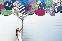  ??  ?? Kelsey Montague is an Instagram-famous mural artist whose vibrant works often feature butterfly wings. She was chosen to create the ME! mural in Nashville for pop star Taylor Swift, left, featuring a giant pair of wings, to promote the singer’s chart-topping single earlier this year.