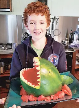  ??  ?? Flynn Musgrove1, 1 of Lardner shows off his Freddy the watermelon shark creation.