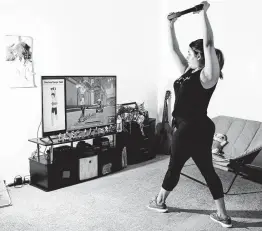  ?? Rozette Rago / New York Times ?? Tiffany Ruiz works out with Nintendo’s “Ring Fit Adventure” game at home in Bakersfiel­d, Calif. The game is the latest effort by the video game industry to try to entice consumers to get up off the couch and become more active.