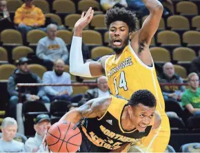  ?? DAVE KALLMANN / MILWAUKEE JOURNAL SENTINEL ?? Northern Kentucky guard Lavone Holland II drives past UW-Milwaukee forward Vance Johnson on Thursday night.