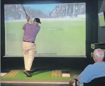  ?? ASSOCIATED PRESS ?? A visitor to the World Golf Hall of Fame in St. Augustine, Fla., tries out a golf simulator.